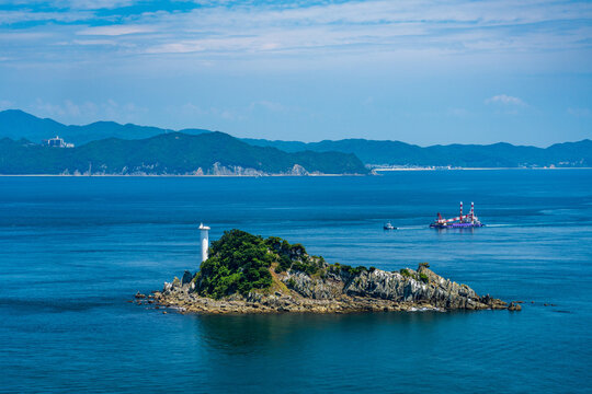Tobishima Island with a white lighthouse floating in the Naruto Strait.