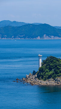 Tobishima Island with a white lighthouse floating in the Naruto Strait.