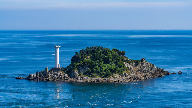 Tobishima Island with a white lighthouse floating in the Naruto Strait.