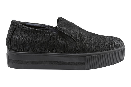 Women black textured platform slip-on sneakers isolated on white background. Casual grunge style flatform shoes, side view.