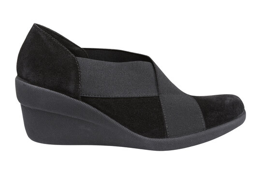 Black women suede wedge shoes isolated on white background. Comfortable casual slip-on pumps with elastic crossover straps, side view.