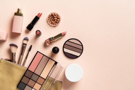 Cosmetic bag with brushes, lipstick, parfum, shadow.