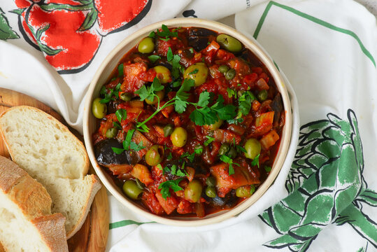 Traditional Sicilian caponata, a vegetable appetizer made with eggplant, olives, and capers in ceramic bowl