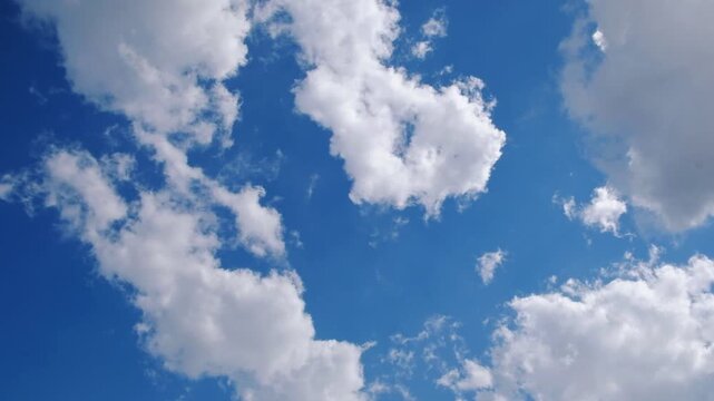 Blue sky with scattered white clouds, a clean natural background for weather, freedom, travel, and environmental concepts.