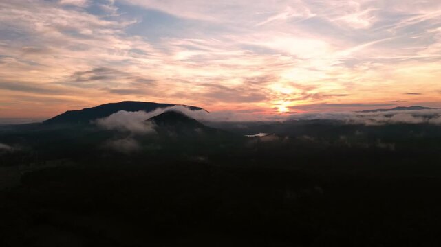 Fog drifts over forested mountain ridges at sunrise, Ocoee, Tennessee