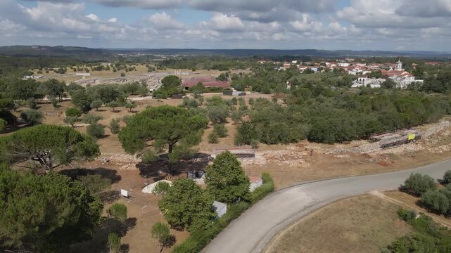 Drone perspective capturing conservation progress on Con&iacute;mbriga&rsquo;s perimeter fortifications. Aerial glide over Con&iacute;mbriga showing detailed rebuilding work on ancient defensive walls.