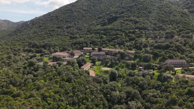 Abandoned mining village of Orbai in Sardinia, Italy, showing old mining structures, rural terrain and the surrounding Mediterranean landscape - drone shot