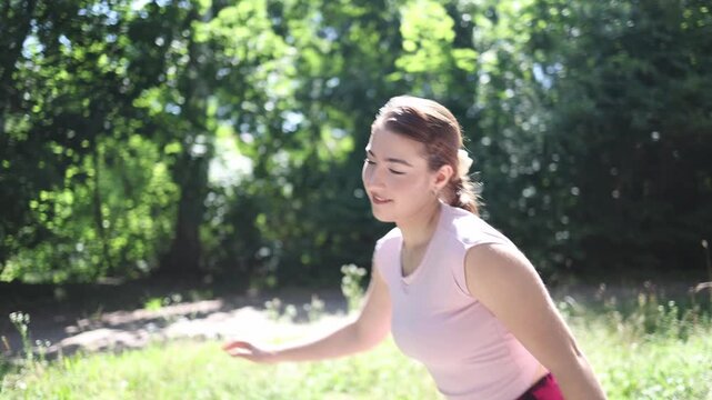 Young woman enjoys her favorite hobby of inline skating smiling with confidence while spending an active summer day outdoors in a peaceful green park