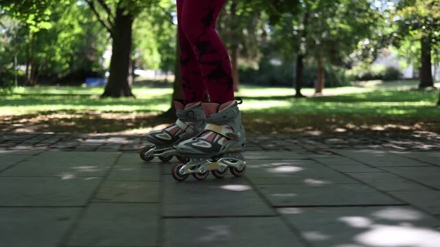 Close up of inline skates gliding smoothly along a park path emphasizing stable technique controlled movement and confident outdoor fitness practice