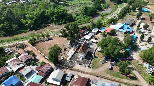High angle aerial view of Wat Sri Kaew in Nong Bua Lamphu, Thailand, highlighting a cultural landmark and Buddhist temple within a scenic countryside setting. Nov 2023.