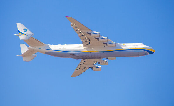 Plane Antonov AN-225 Mriya biggest airplane in the world. UR-82060 aircraft Air cargo plane flying in blue sky. Hostomel, Ukraine - April 23, 2020