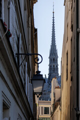 Fototapeta premium Sainte Chapelle Spire Framed by Narrow Historic Paris Street Buildings
