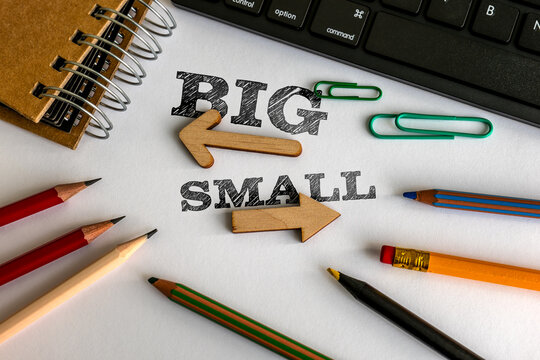 BIG and SMALL Direction Concept with Wooden Arrows and Colorful Pencils