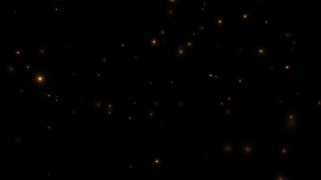 Smoothly flying glowing particles on a black background. Golden particles, shimmering light particles, magical golden dust. 4K video.