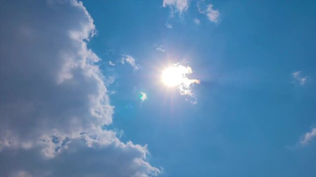 Time-lapse of Sun Shining Through Moving Cumulus Clouds in a Clear Blue Sky