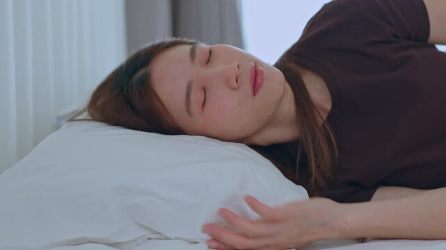 Woman sleeping bed pillow bedroom rest peaceful indoor relaxation sleep calm face closed eye soft light home side view white pillow restful bedroom scene