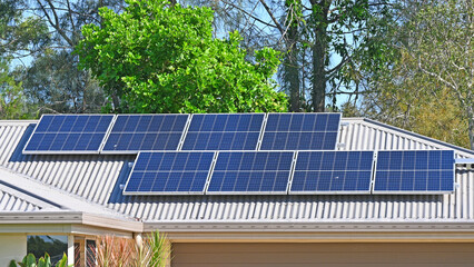 Solar electric panels on a house roof © Douglas Cliff