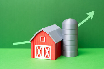 Farmer's barn and growth arrow. Improving agricultural business, increasing yields, profits, and efficiency. Improving the environment. Growth of the agricultural sector. © Andrii Yalanskyi