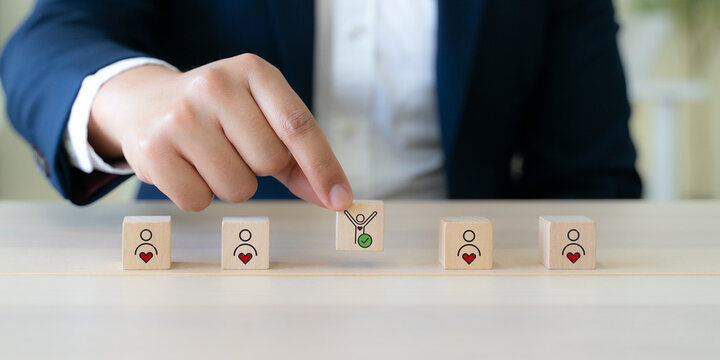 Employee Motivation or Brand Loyalty concept. Wooden blocks with employee blocks with heart symbols, representing motivation, brand loyalty, employee engagement, recognition and commitment.