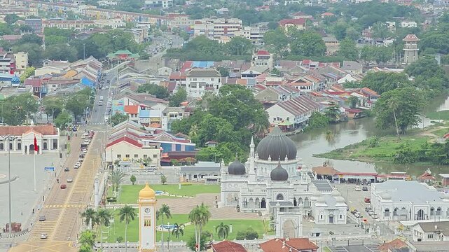 Beautiful mosque in Alor Setar, Malaysia, showcasing elegant Islamic architecture and a peaceful cityscape beneath an open blue sky.