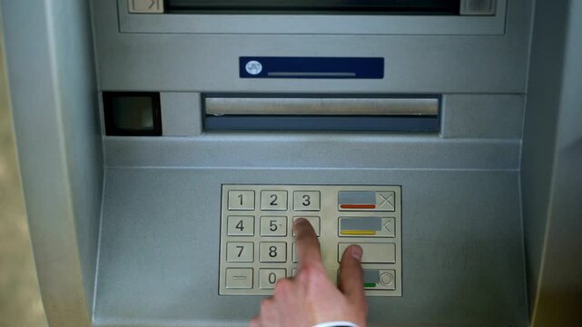Man correcting pin code on ATM keyboard to transfer funds between bank accounts for secure electronic financial transaction in 4K Ultra HD footage
