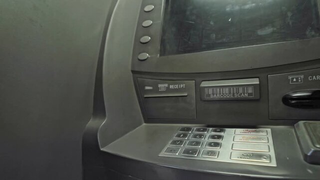 Hands of a man using the ATM machine to insert debit card and navigate financial screen for secure banking transaction in 4K Ultra HD footage
