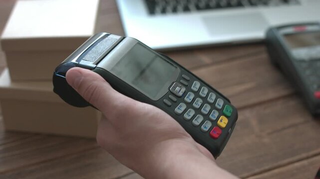 Mans hand pushing the button and swipe credit card on electronic terminal for consumer retail payment transaction in 4K Ultra HD footage
