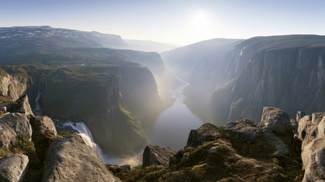 High Angle Overlook of Alpine Canyon with Winding River Waterfall and Snow-Patched Plateaus