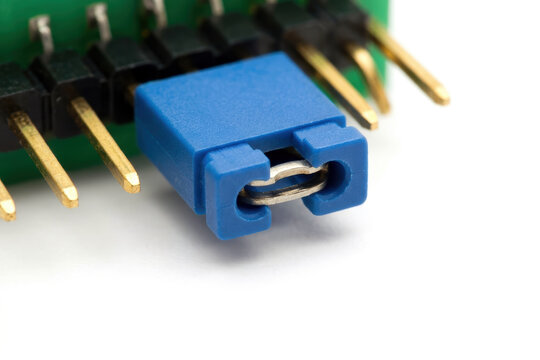 Blue jumper shunt on green circuit board