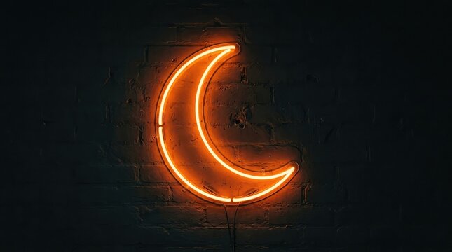 Glowing orange neon crescent moon shape isolated on a dark black background for modern minimalist design