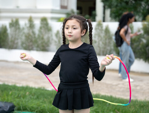 Young girl jumping rope outdoors