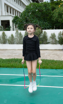 Young girl jumping rope outdoors