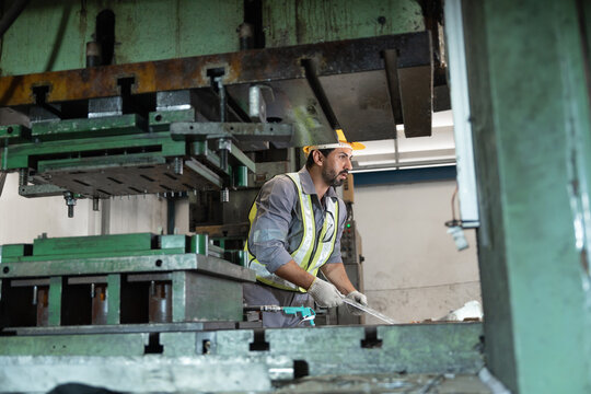 Industrial workers working and control machine at auto parts factory