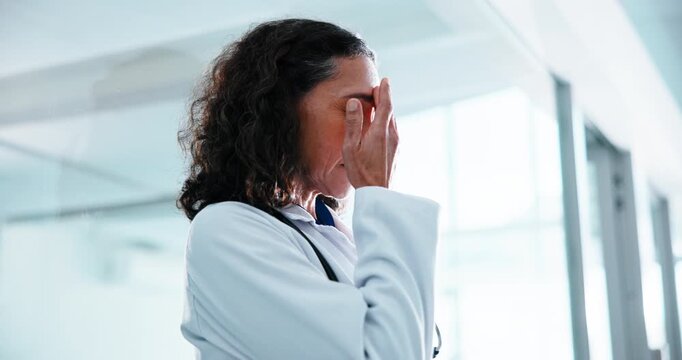 Doctor, woman and headache with stress in hospital for bad news, fail procedure or mistake. Mature, female person or tired healthcare worker with migraine or anxiety for pressure, strain or burnout