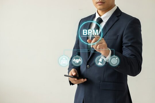 Businessman touches bpm icons representing business process management and workflow optimization.