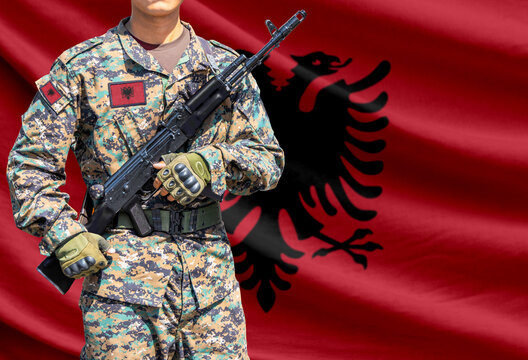 Albania flag with soldier holding assault rifle