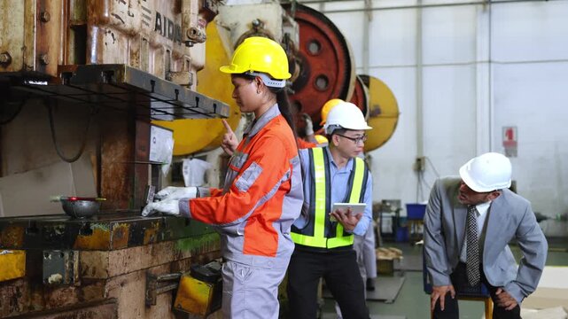 Team of engineers working together in an industrial workshop focusing on quality assurance and enhancing processes