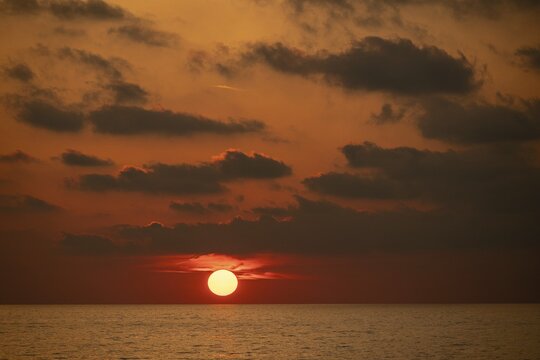 Sunset bathes the sky and clouds in shades of red and orange, Aeolian or Lipari Islands, Southern Italy, Italy
