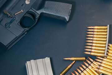 Rifle ammunition bullets on stripper clips with weapon background. Real photograph, not AI-generated © TimeStopper