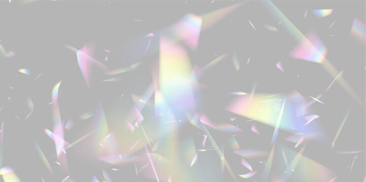Scattered translucent prism fragments displaying diffuse rainbow reflections on a dark background on transparent background