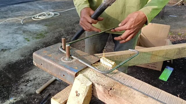 Close-up footage of a construction worker making steel rebar stirrups for reinforced concrete columns