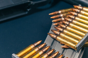 Rifle ammunition bullets on stripper clips with weapon background. Real photograph, not AI-generated © TimeStopper