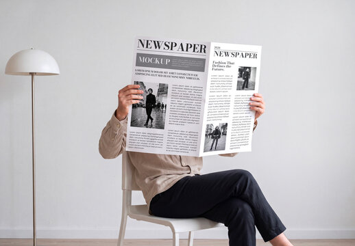 Man Reading Folded Newspaper Mockup Sitting on a Chair