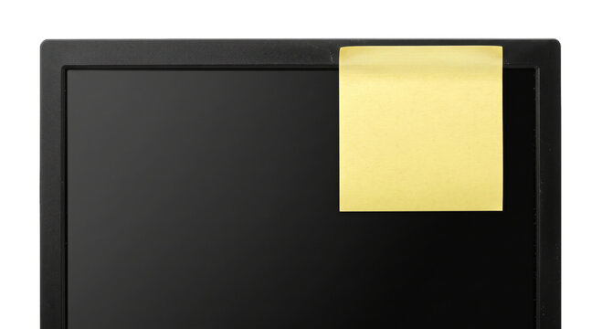 Yellow sticky note attached to the corner of a black computer monitor screen