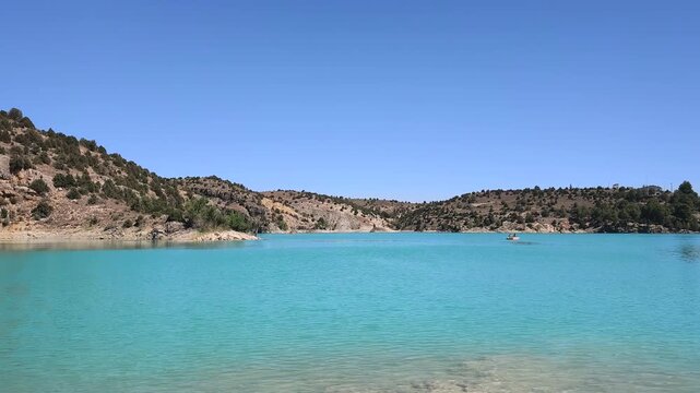 Panoramic view of the Teruel reservoir in spain with its turquoise waters on a blue sky day
