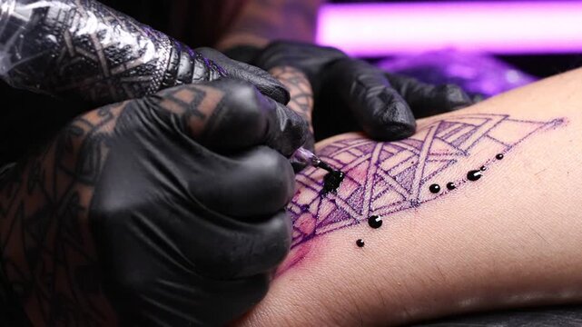 Tattoo Artist Applying Ink to Skin with Machine Close up