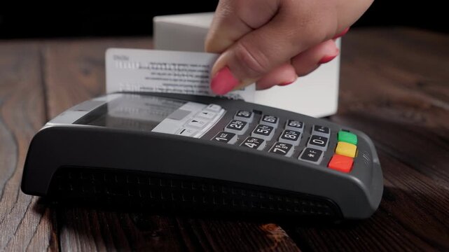 Female hands holding credit card and navigating secure electronic bank terminal for fast retail payment transaction in 4K Ultra HD footage
