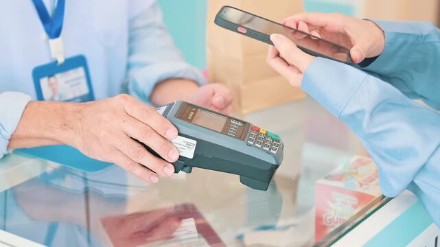 Contactless online payment with unrecognized person holding smartphone to make secure digital banking transaction on laptop computer in 4K Ultra HD footage
