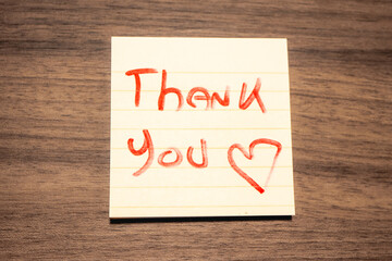 A handwritten note with the text Thank You  on it. © Sonny