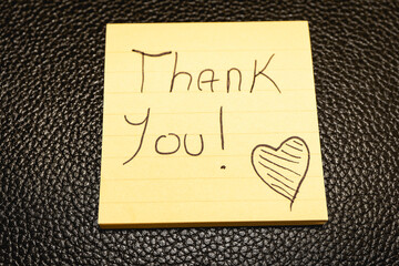 A handwritten note with the text Thank You  on it. © Sonny